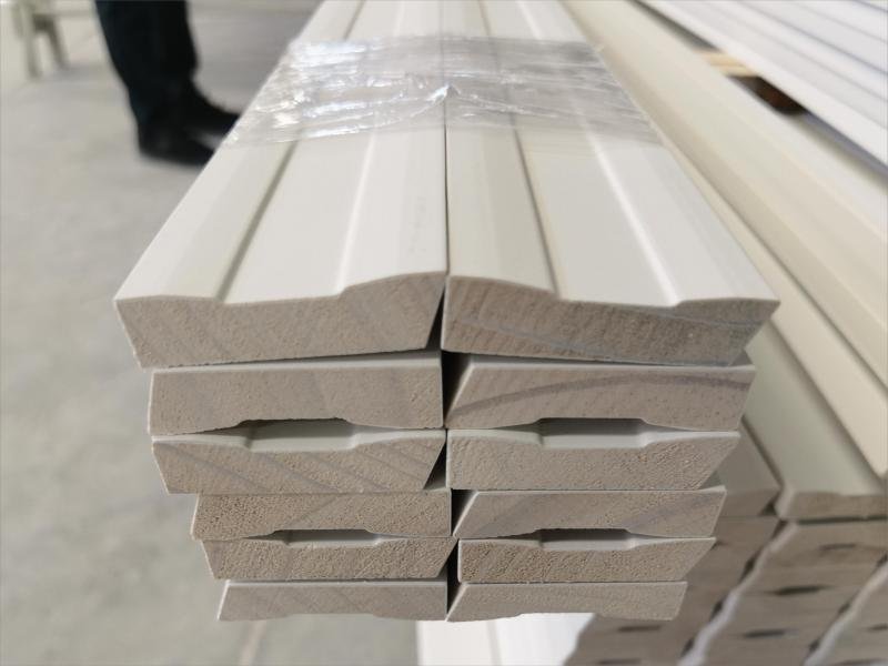 Quality inspector testing moisture content of solid wood mouldings