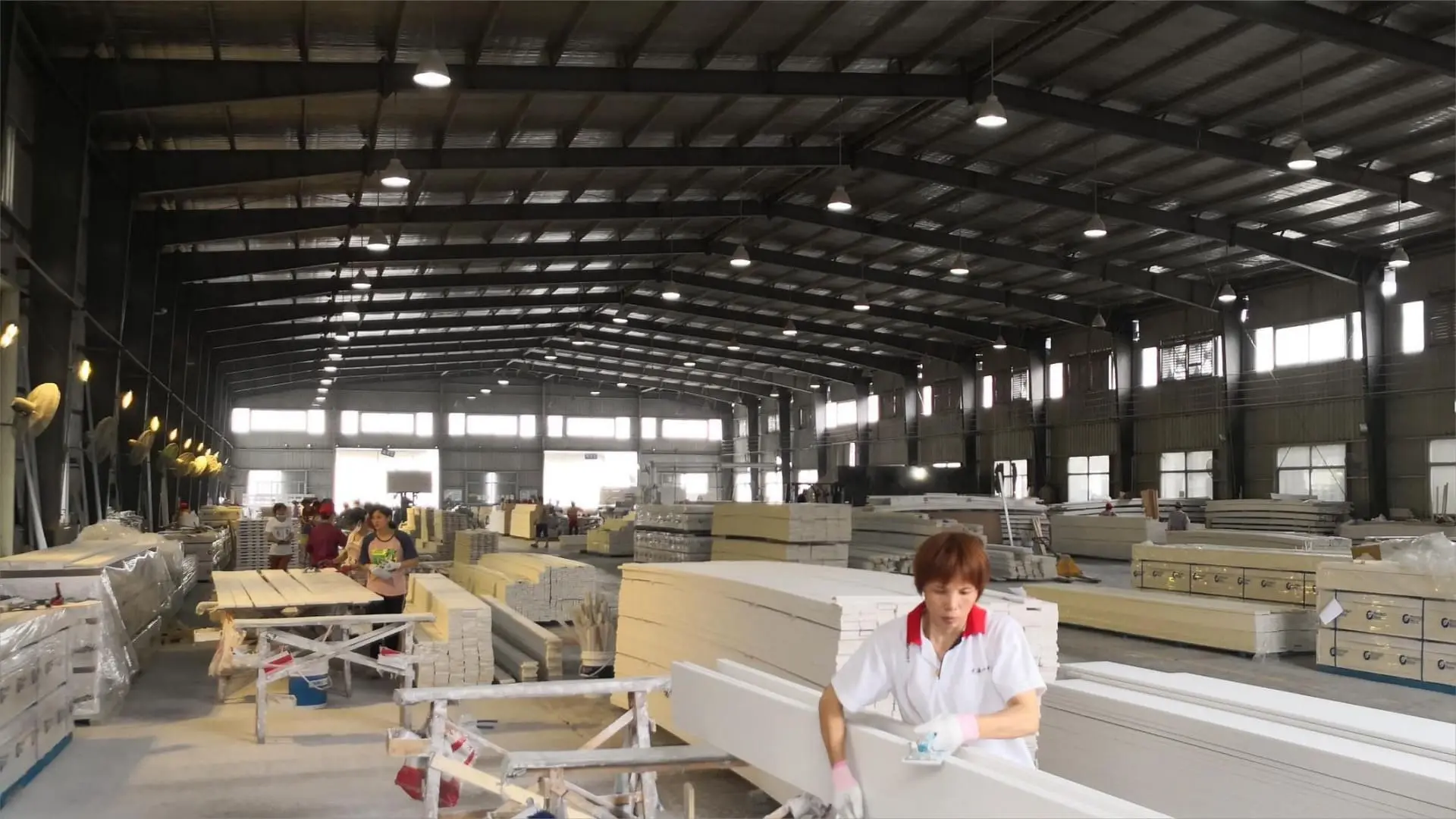 Wide interior view of the Goodwood Mouldings factory floor with wood moulding profiles staged on the production line