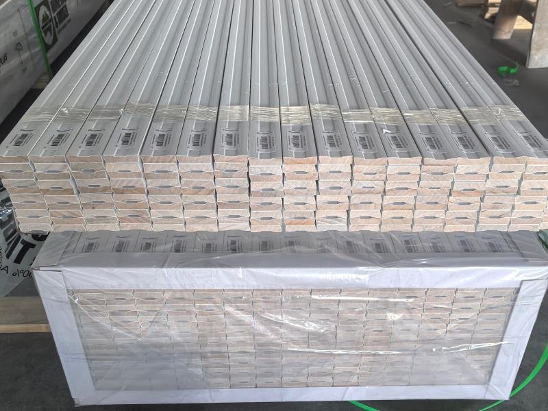 Finished wood moulding profiles stacked and ready for export packaging at Goodwood Mouldings' Xiamen facility